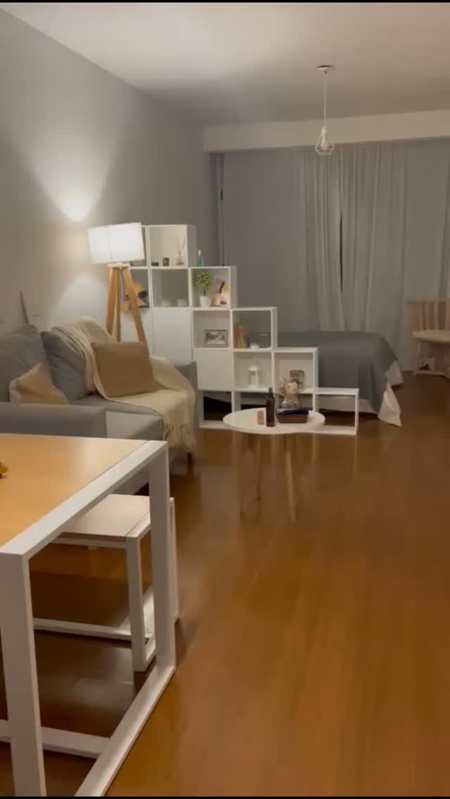 13 Cube Organizer Ideas for Your Living Room Layout 14 White tiered cube organizer acting as a room divider between a living area and bedroom.