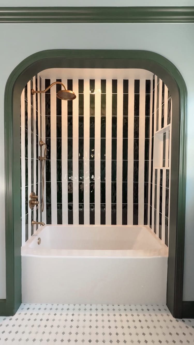 Bathroom Alcove Ideas: 29 Designs for Tubs, Showers & More 2 White bathtub in an arched alcove with black and white striped wall tiles.