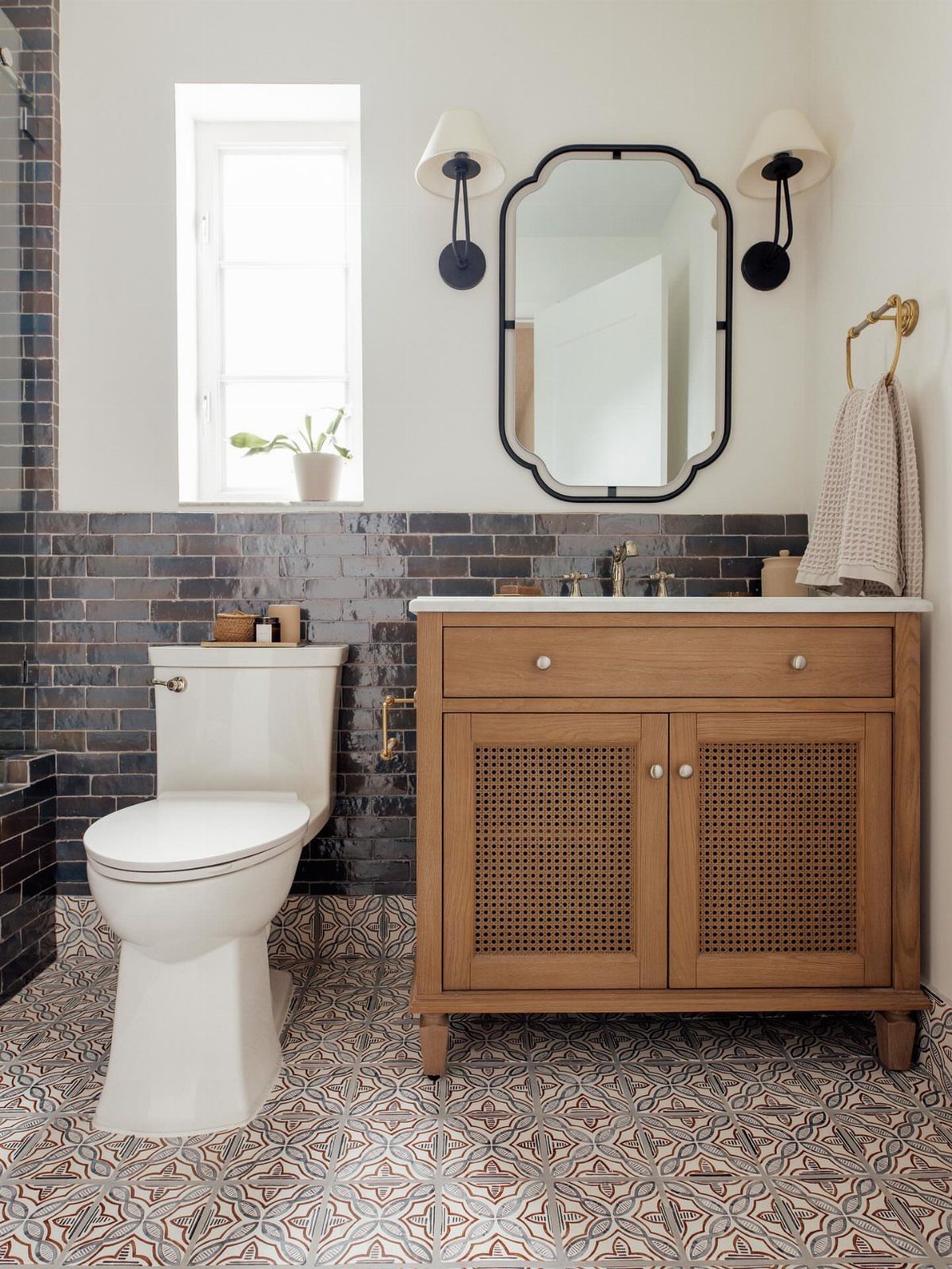 Bathroom Alcove Ideas: 29 Designs for Tubs, Showers & More 5 Bathroom with dark grey tile wainscoting, wooden vanity, and patterned floor tiles.