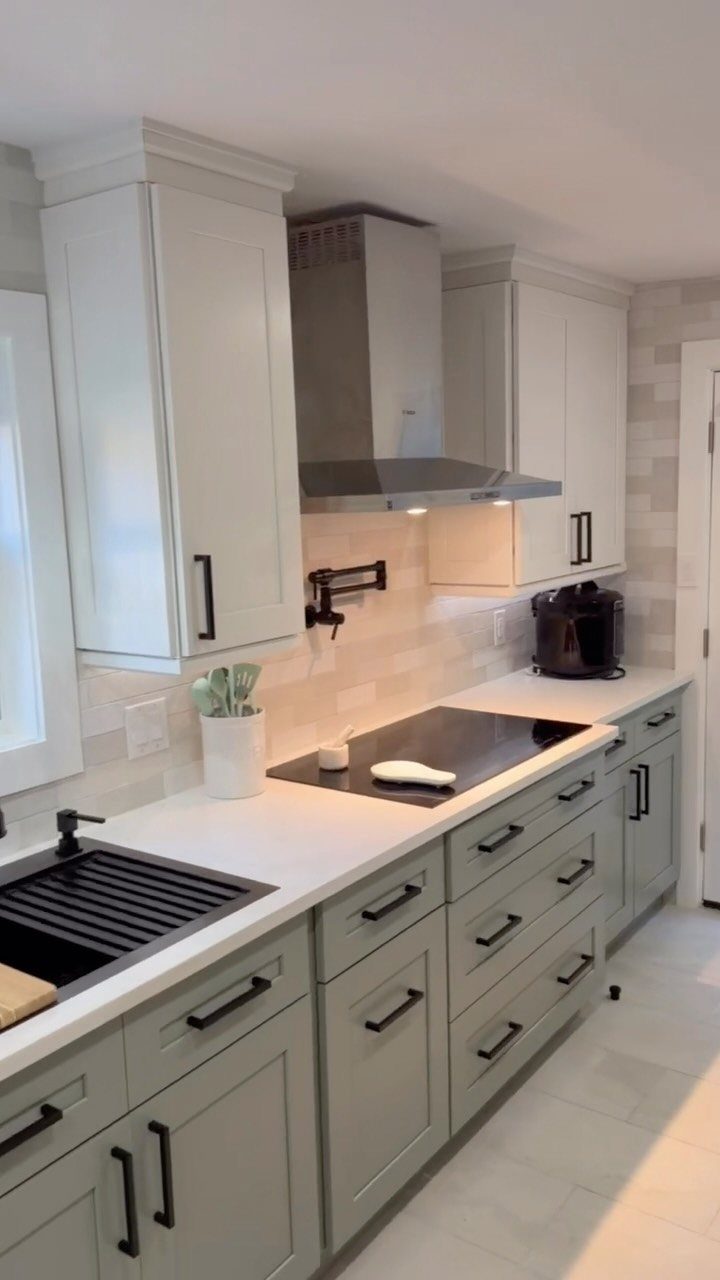 32 Simply Kitchen Design Ideas for a Clean, Modern Space 14 White upper and sage green lower cabinets in a modern kitchen with white countertops.