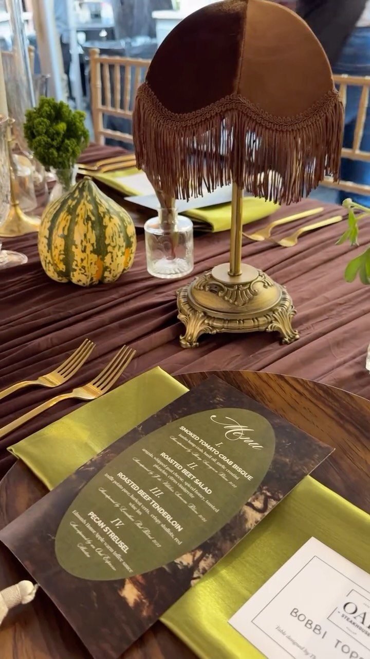 Table Decor for Round Tables: 13 Ideas to Try at Home 12 Autumn table setting with a decorative gourd, vintage lamp, and gold cutlery.
