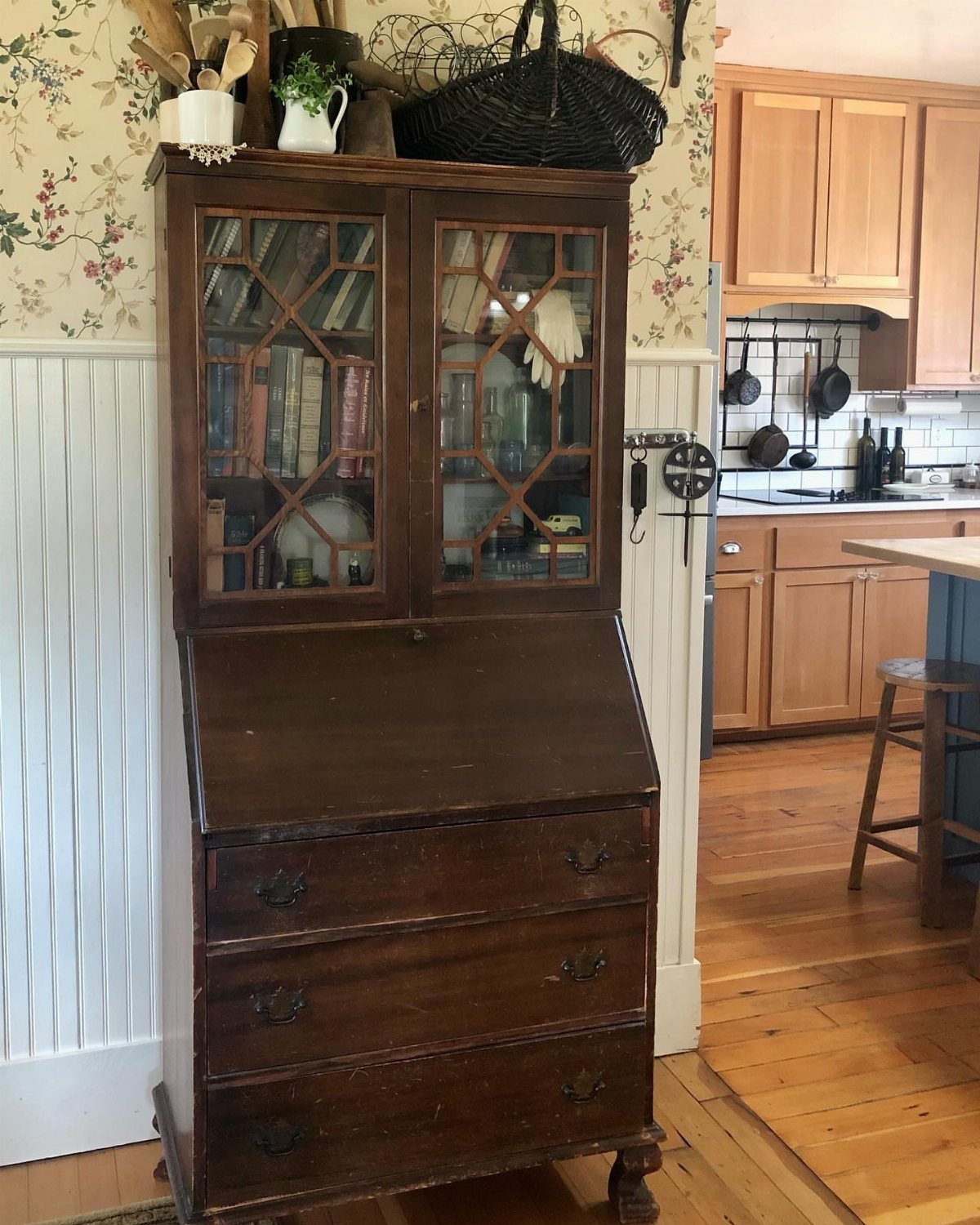 Vintage dark wood secretary desk with a glass-door hutch and slant-front writing surface.