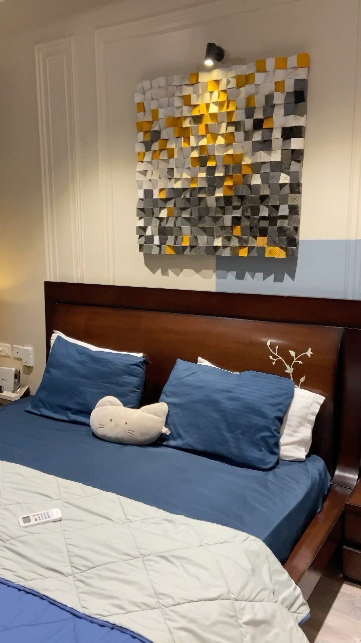 Master Bedroom Interior Design: 16 Ideas for a Better Space 16 Bedroom with blue bedding and a textured yellow and grey wall art piece.