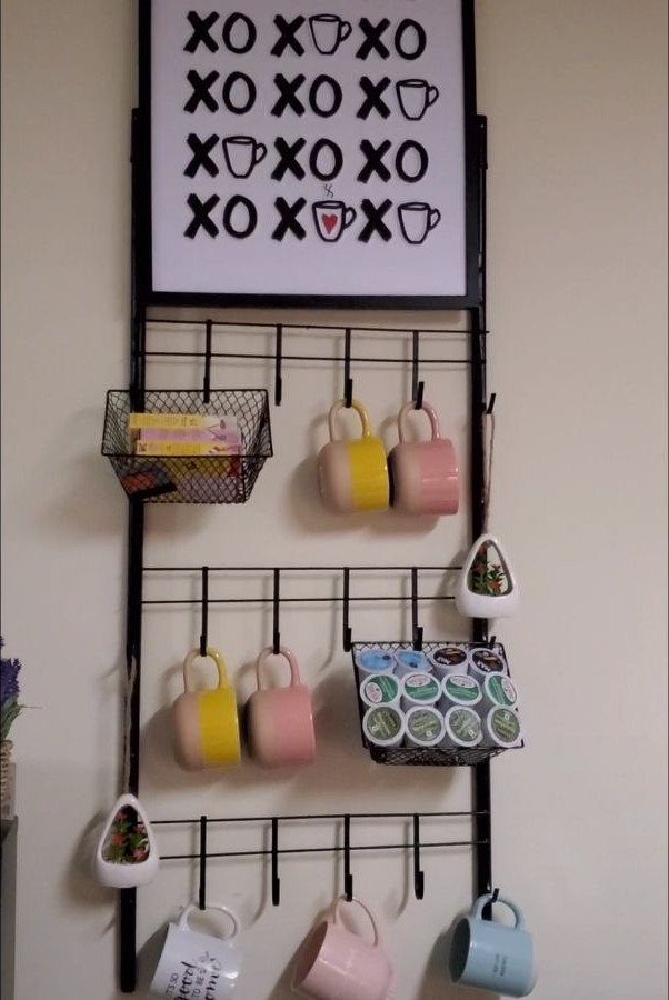 Wall Mounted Coffee Bar: 23 Stylish Space-Saving Ideas 24 Wall mounted coffee bar with a black grid holding mugs and coffee pods.